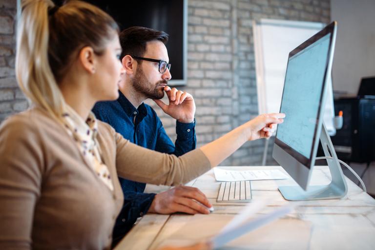 shutterstock_722984446.jpg Two tech professionals studying for agile certifications